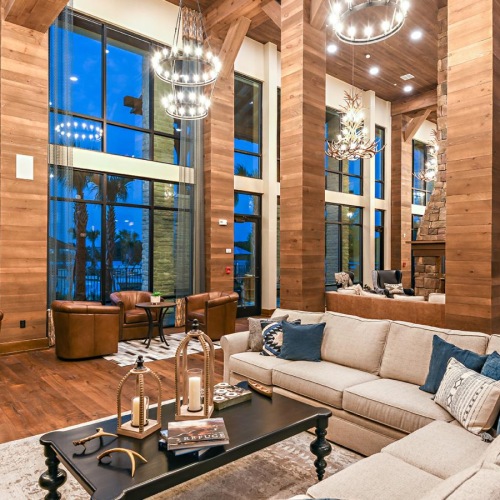 a large room with a couch, chairs and tables