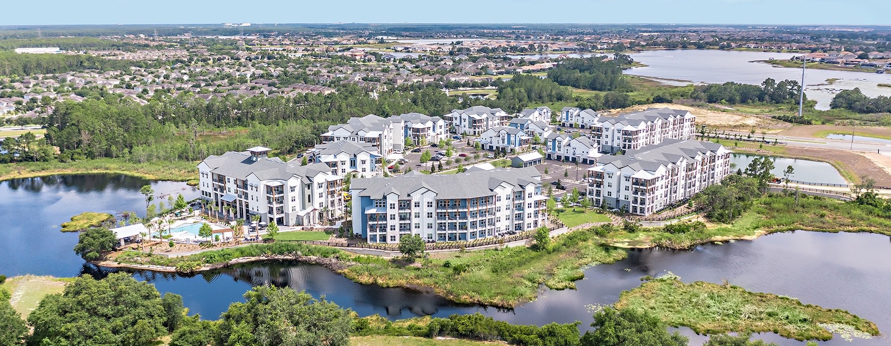a large white building next to a river