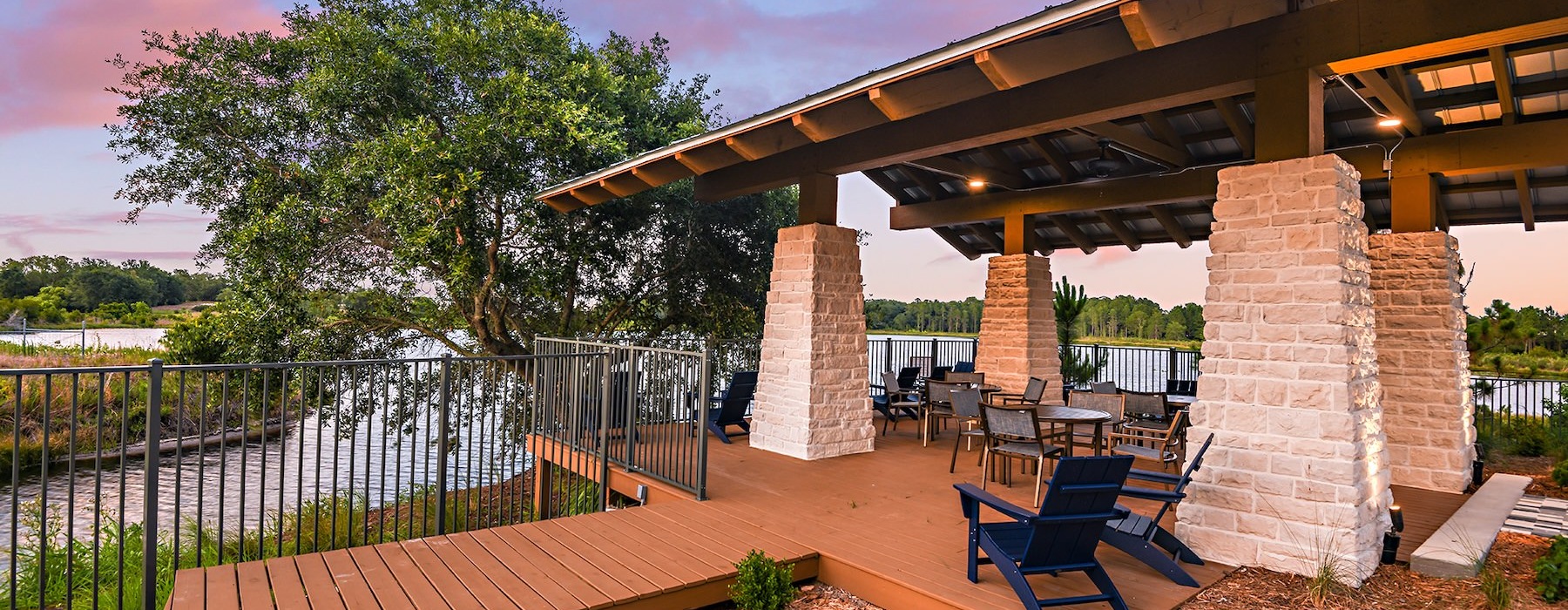 a deck with chairs and stone pillars