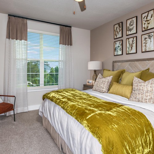 a bedroom with a bed and a fan