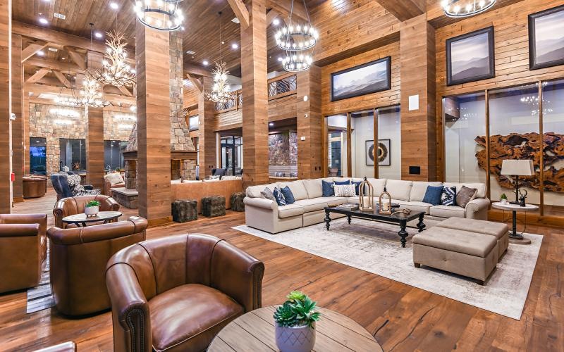 a lounge with a couch, tables and chairs